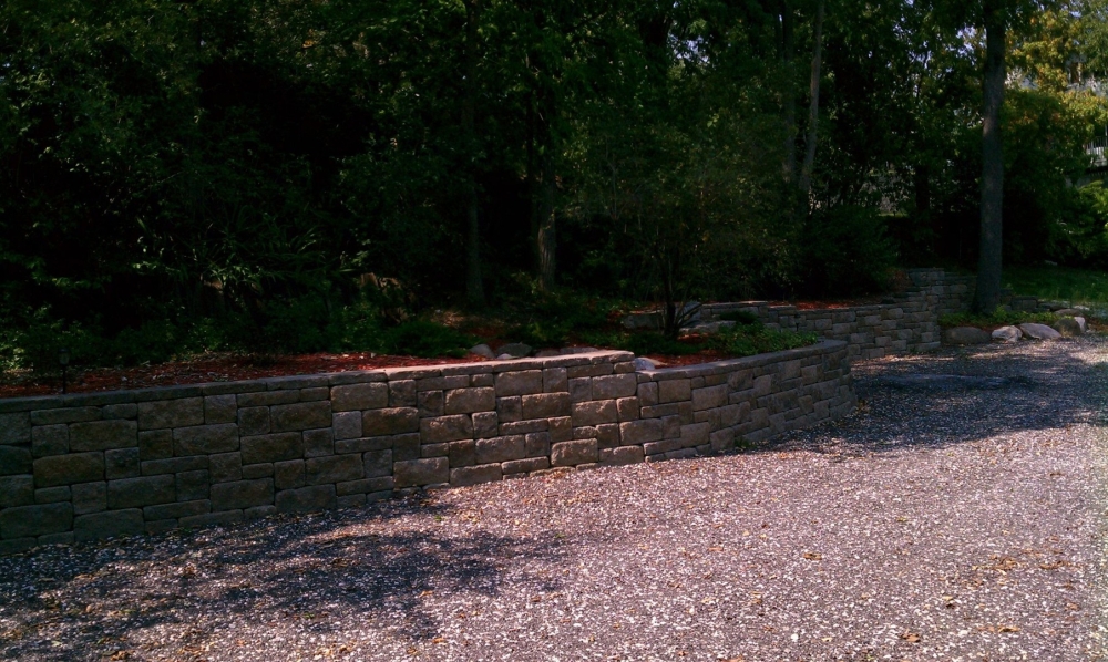 A yard is opened up after a retaining wall is installed